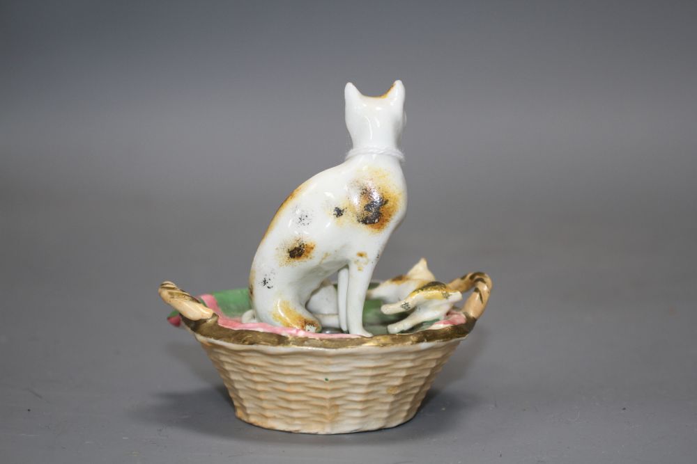 A Staffordshire porcelain group of a cat and two kittens in basket, c.1830-50, possibly Dudson,